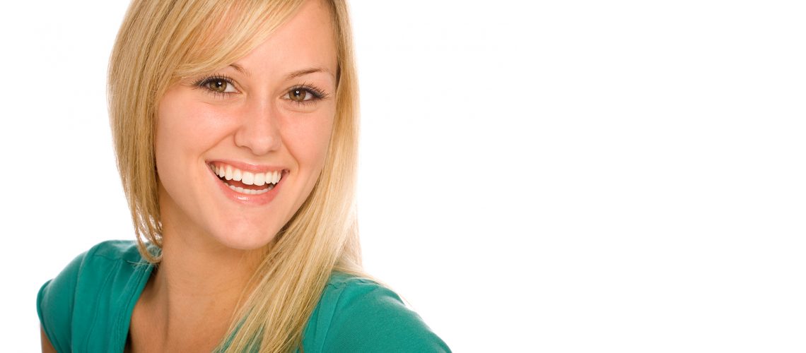 Happy Young Blond Woman Smiling. Isolated on a White Background.